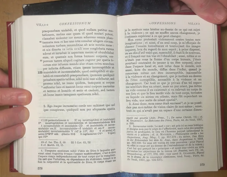 A book spread photographed at a desk under overhead light.